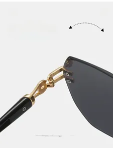 Macro view of durable gold metal hinges and dark lenses on rimless sunglasses