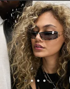 Close-up of futuristic rimless wrap-around metal sunglasses with silver rivets