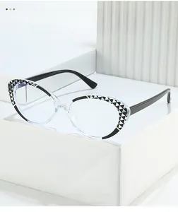 Detailed view of cat-eye frames featuring black and white geometric patterns on a pedestal