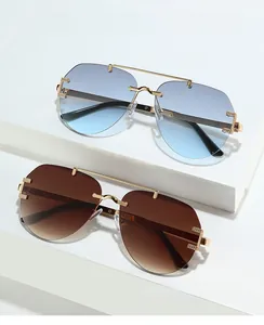 Detail of gradient blue and brown aviator sunglasses with gold metal double bridge