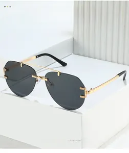 Detail of gold metal double bridge and engraved hinges on aviator sunglasses