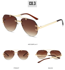 Detail view of gold aviator sunglasses with brown gradient lenses and metal frame