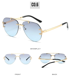 Detail of aviator sunglasses with blue gradient lenses and golden metal frames