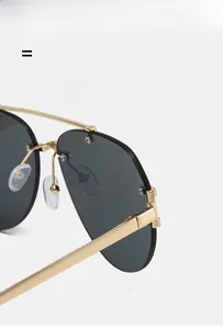 Detail of lightweight golden metal nose pads and flexible bridge on aviator sunglasses