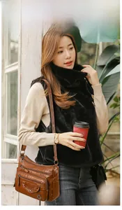 Brown vintage faux leather crossbody bag with multiple zip pockets shown on a model