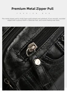 Detail of gold-plated zipper on soft black pebbled leather crossbody bag