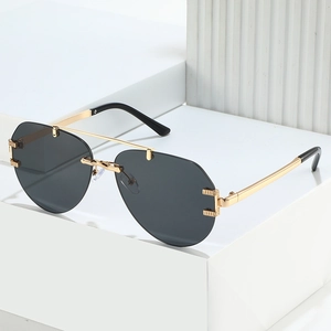 Pilot sunglasses with gold double-bridge metal frame and dark gray lenses on white pedestal