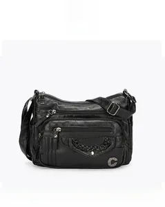Detailed front view of a black multi-pocket crossbody bag with vintage leather texture
