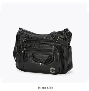 Detail view of black soft PU leather crossbody bag with multiple zippers and woven texture