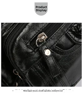 Close-up of premium black pebbled leather texture and smooth metal zipper details on bag