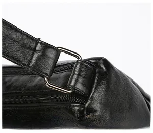 Detail of durable silver hardware D-ring and smooth black leather strap stitching