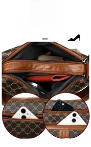 Detail showing multi-layer storage capacity for phone and wallet in brown monogram bag