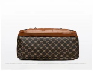 Detailed bottom view of large capacity crossbody bag with brown geometric pattern