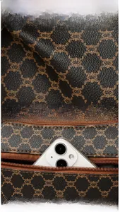 Detail of vintage monogram leather shoulder bag with a back zipper pocket for smartphone