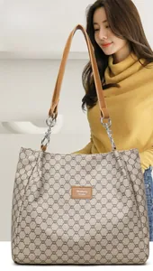 Detail of vintage geometric pattern tote bag with leather straps and metal hardware