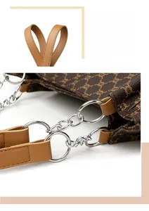Detail of vintage brown tote bag featuring luxury monogram leather and silver chain links