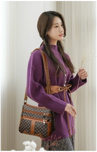 Detail of vintage triomphe pattern shoulder bag with multiple zippers for daily commute