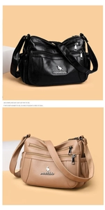 Close-up of black and apricot crossbody bags with multi-zipper pockets and leather texture