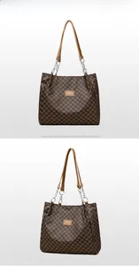 Detail view of vintage brown pattern tote bag with stylish silver metal chain straps
