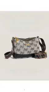 Detail of beige canvas crossbody bag with black letter print and kangaroo logo