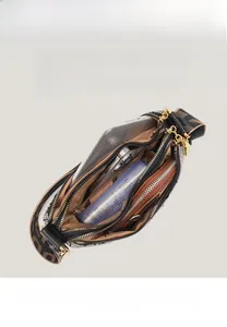 Top view showing the spacious multi-pocket interior of the soft leather shoulder bag