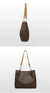 Detail of vintage brown tote bag with classic pattern and silver metal chain strap