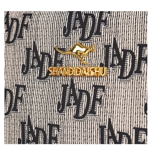 Detailed macro view of the kangaroo metal logo and letter printed canvas fabric