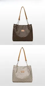 Detail of large brown and grey tote bags with Y-pattern faux leather and chain straps
