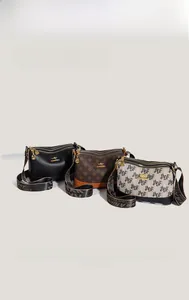 Detailed view of three soft leather shoulder bags with various patterns and wide straps