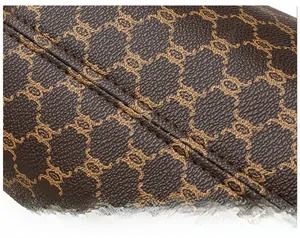Macro shot of precise double stitching on retro brown PU leather with geometric pattern