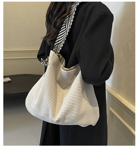 Close-up of white corduroy tote bag featuring a stylish zebra print wide shoulder strap