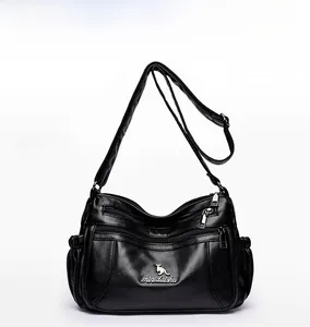 Close-up of black crossbody bag front with lychee texture and kangaroo metal logo