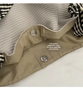 Close-up of canvas tote bag with invisible magnetic buckle closure and corduroy lining