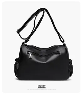 Back view of black textured leather crossbody bag with multiple zip pockets and side folds
