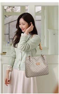 Detail of vintage faux leather tote bag with geometric pattern and silver chain strap
