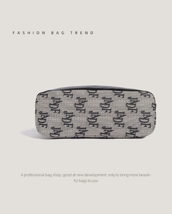 Detail view of jacquard fabric base and leather stitching on the large shoulder bag