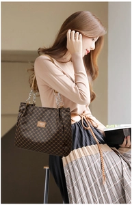 Detail of vintage patterned PU leather tote bag with elegant silver chain shoulder strap