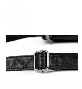 Detail of black pebbled leather strap with silver square metal adjustment buckle