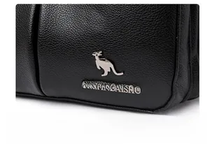 Close-up of black lychee leather texture with silver kangaroo logo and lettering