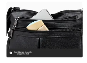 Detail showing high-capacity front zipper pockets on black pebble leather handbag
