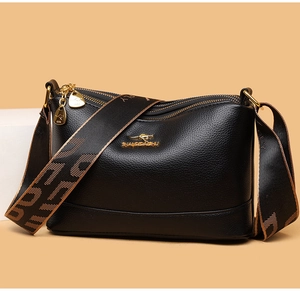 Detail of soft black leather texture with gold kangaroo logo and jacquard strap