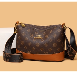 Detailed side view of brown monogram bag with yellow leather trim and woven strap