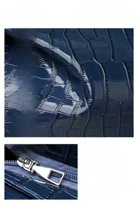 Detail of dark blue crocodile embossed tote bag with high-quality silver metal zipper