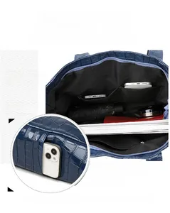 Detailed interior of crocodile texture tote bag showing spacious compartments and pockets