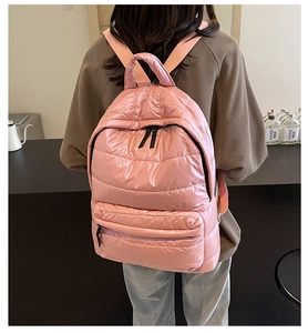 Pink quilted puffer backpack shown from the back on a model for daily leisure look