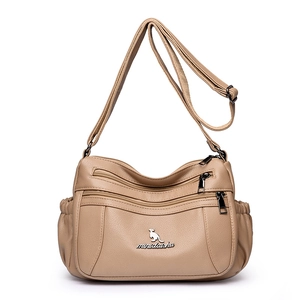 Minimalist beige crossbody bag with multi-pocket design and adjustable shoulder strap