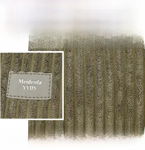 Macro shot of olive green corduroy fabric texture with a premium synthetic leather label
