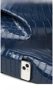 Detail of dark blue crocodile embossed tote bag with side zipper pocket for smartphone