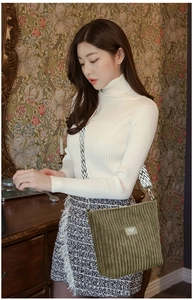 Detail of green corduroy tote bag featuring a geometric pattern wide shoulder strap