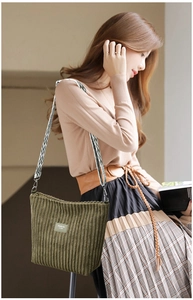 Close-up of dark green corduroy tote bag with ethnic style embroidered shoulder strap